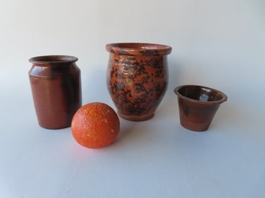 Three pieces of early redware including: A black sponge decorated small pot with rolled rim - small