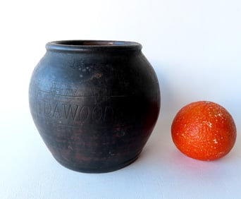 A redware jar with an incised mark within rectangle "D.A. WOODS", with a mat black glaze - very good