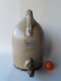 A large stoneware 5 gallon water cooler jug, with wooden spigot and having an impressed mark on the