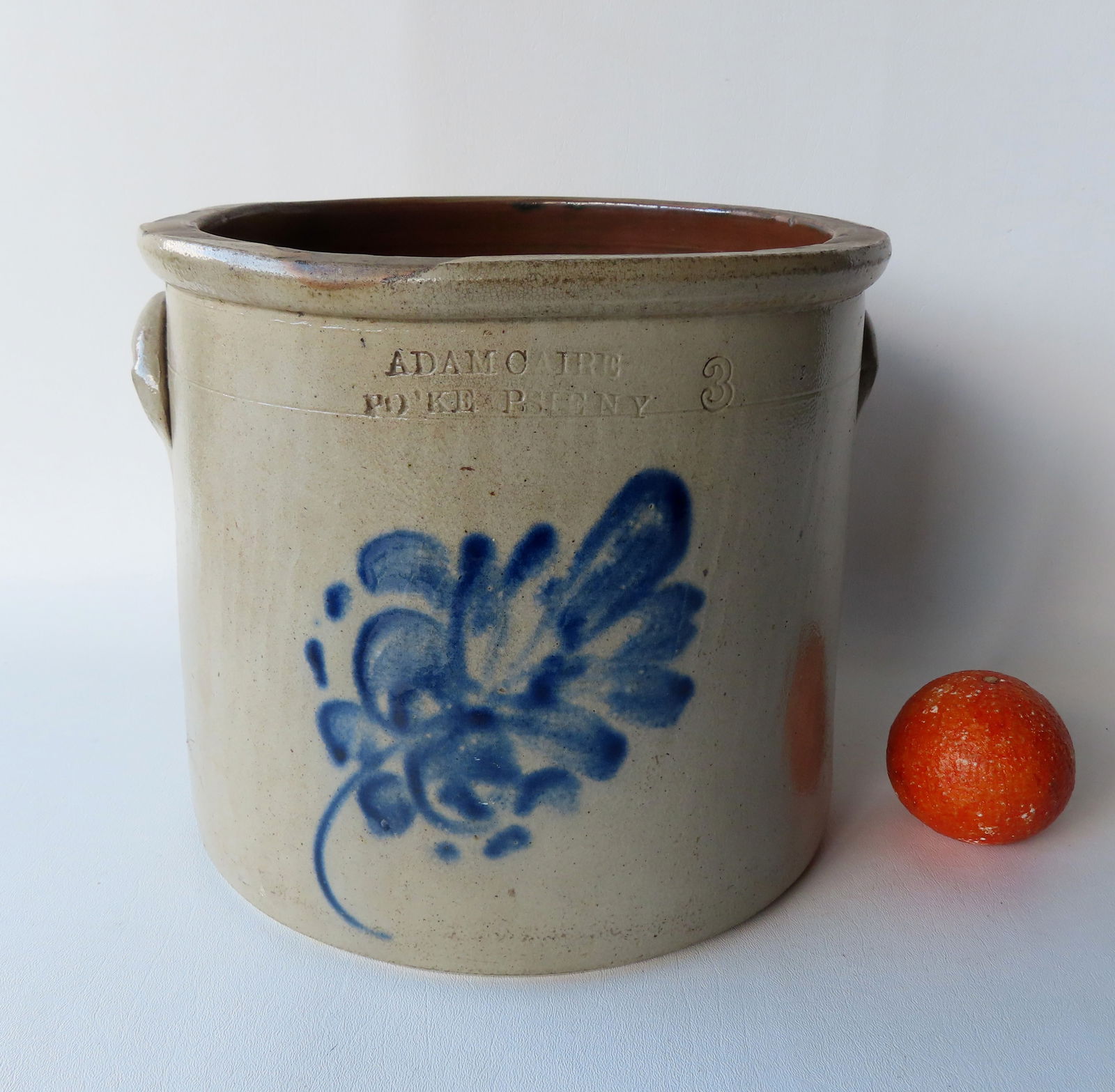 Stoneware crock marked "Adam Caire / Po'Keepsie N.Y." decorated with a large cobalt blue flower and (1 of 7)