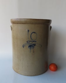 A Large 10 gallon stoneware pickle crock decorated with a small cobalt blue flower and script "10".