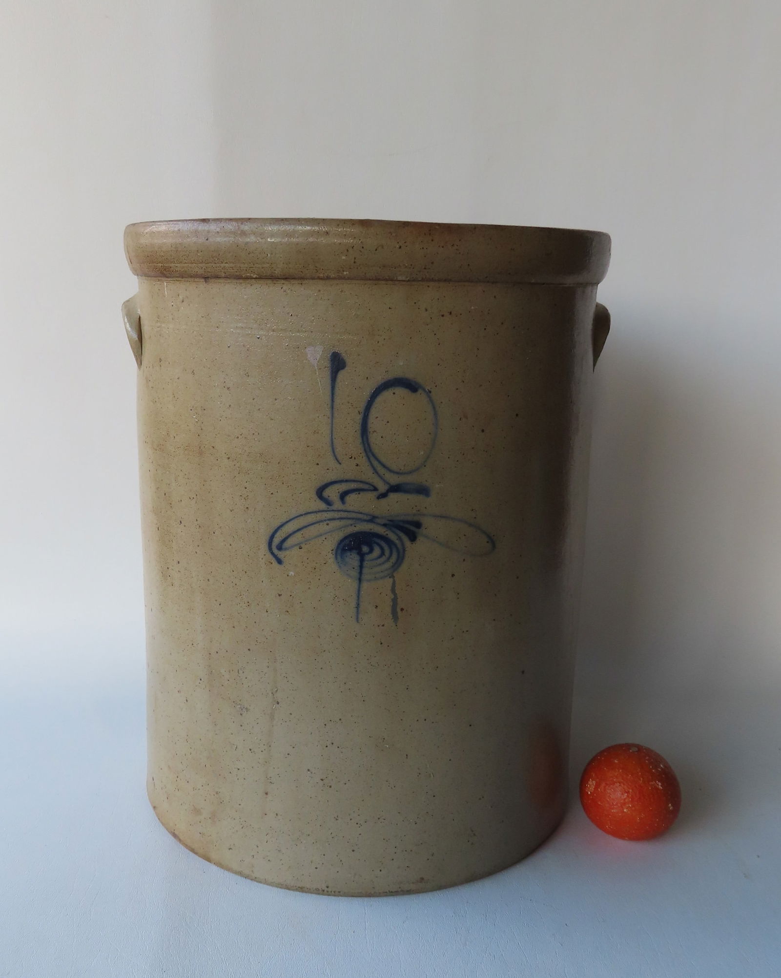 A Large 10 gallon stoneware pickle crock decorated with a small cobalt blue flower and script "10". (1 of 12)