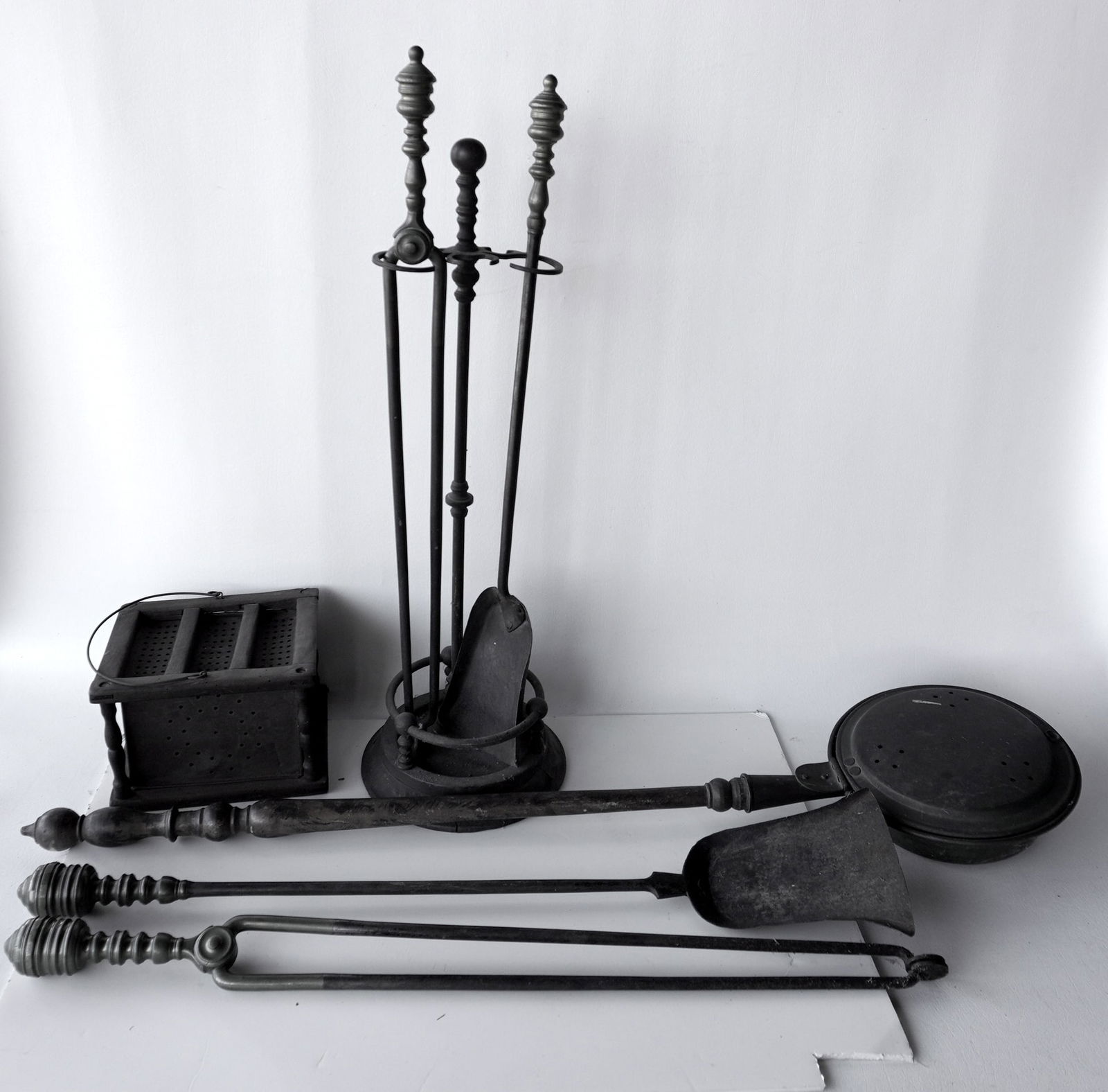 Grouping of hearth items including: Pierced tin foot warmer; a pierced brass bed warmer with a grain (1 of 12)