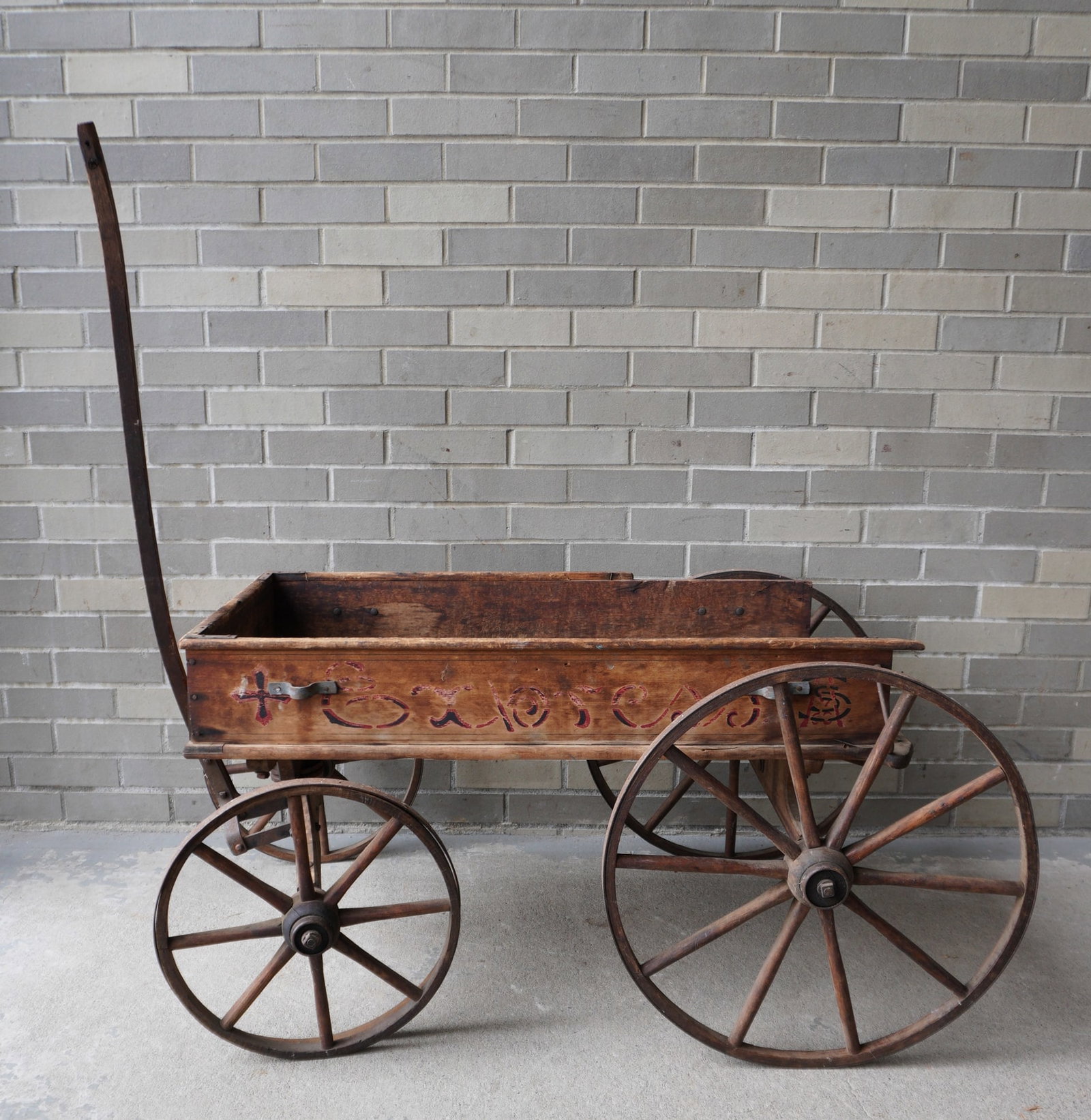 A 19th century stenciled wagon with wooden wheels stenciled "EXPRESS" across the sides - some wear: A 19th century stenciled wagon with wooden wheels stenciled "EXPRESS" across the sides - some wear to paint, missing some trim along the top rear and missing the back board - original paint, fair to g