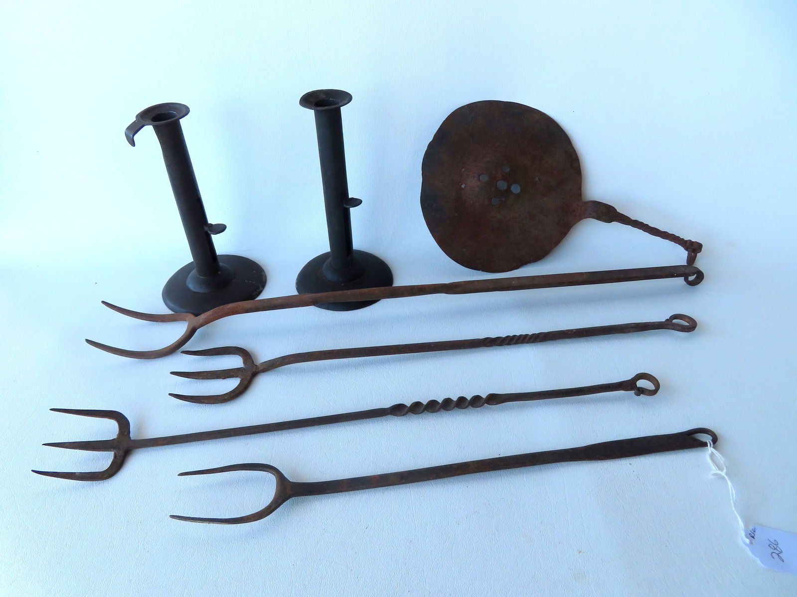 Grouping of early iron and tin kitchen collectibles including: 2 hog scrapper candlesticks - 7"H; a (1 of 7)