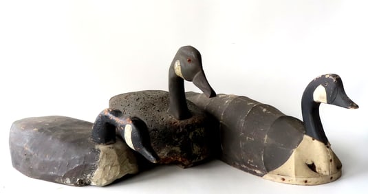 Three primitive goose decoys. 1) Carved wooden goose with hissing head, and body carved from a log -