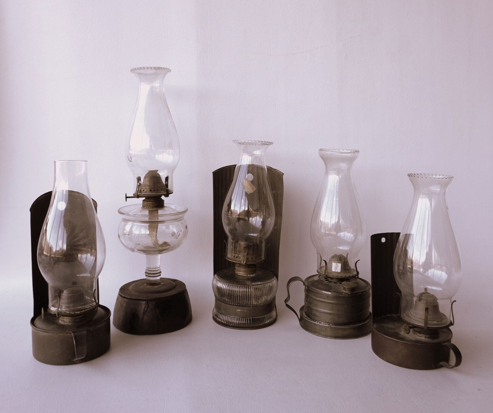 Grouping of 5 oil lamps, including 3 with original tin lamp holders/reflectors for mounting on wall, (1 of 9)