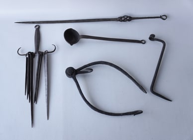 Grouping of early iron hearth tools including a skewer hanger with 8 tools, a larger had forged iron