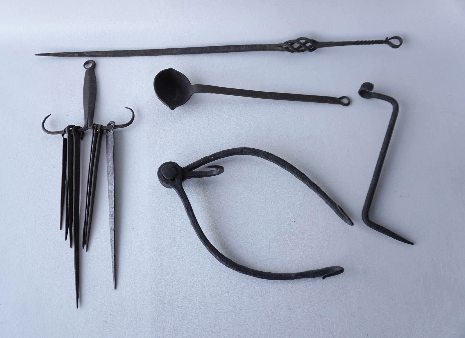 Grouping of early iron hearth tools including a skewer hanger with 8 tools, a larger had forged iron (1 of 9)
