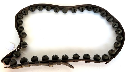 A set of brass sleigh bells with original leather strap - missing buckle, else good condition, 19th