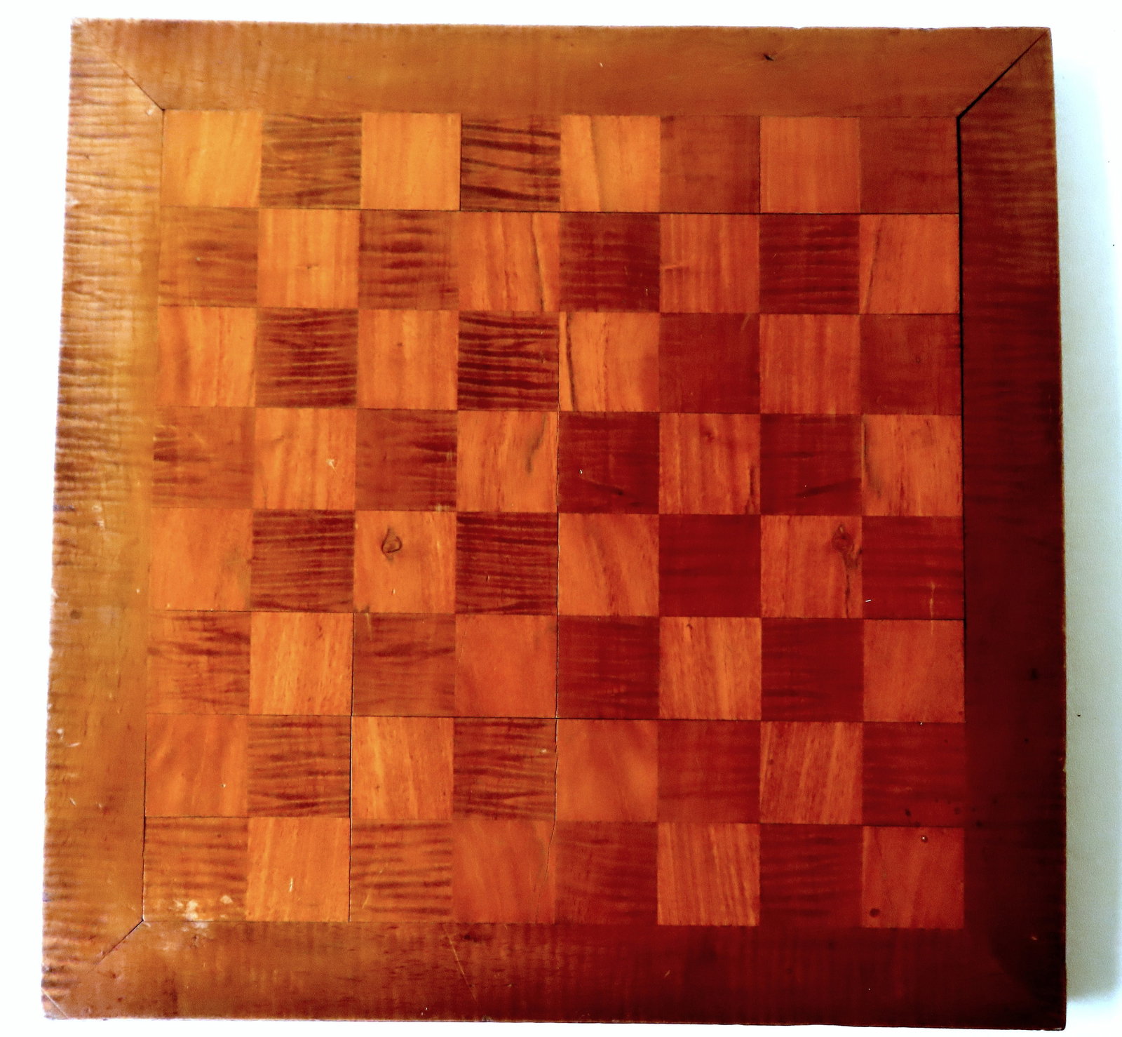 A tiger maple game board, late 19th century. Slight bow in board, else very good condition. Measures: A tiger maple game board, late 19th century. Slight bow in board, else very good condition. Measures approximately 17" x 17".