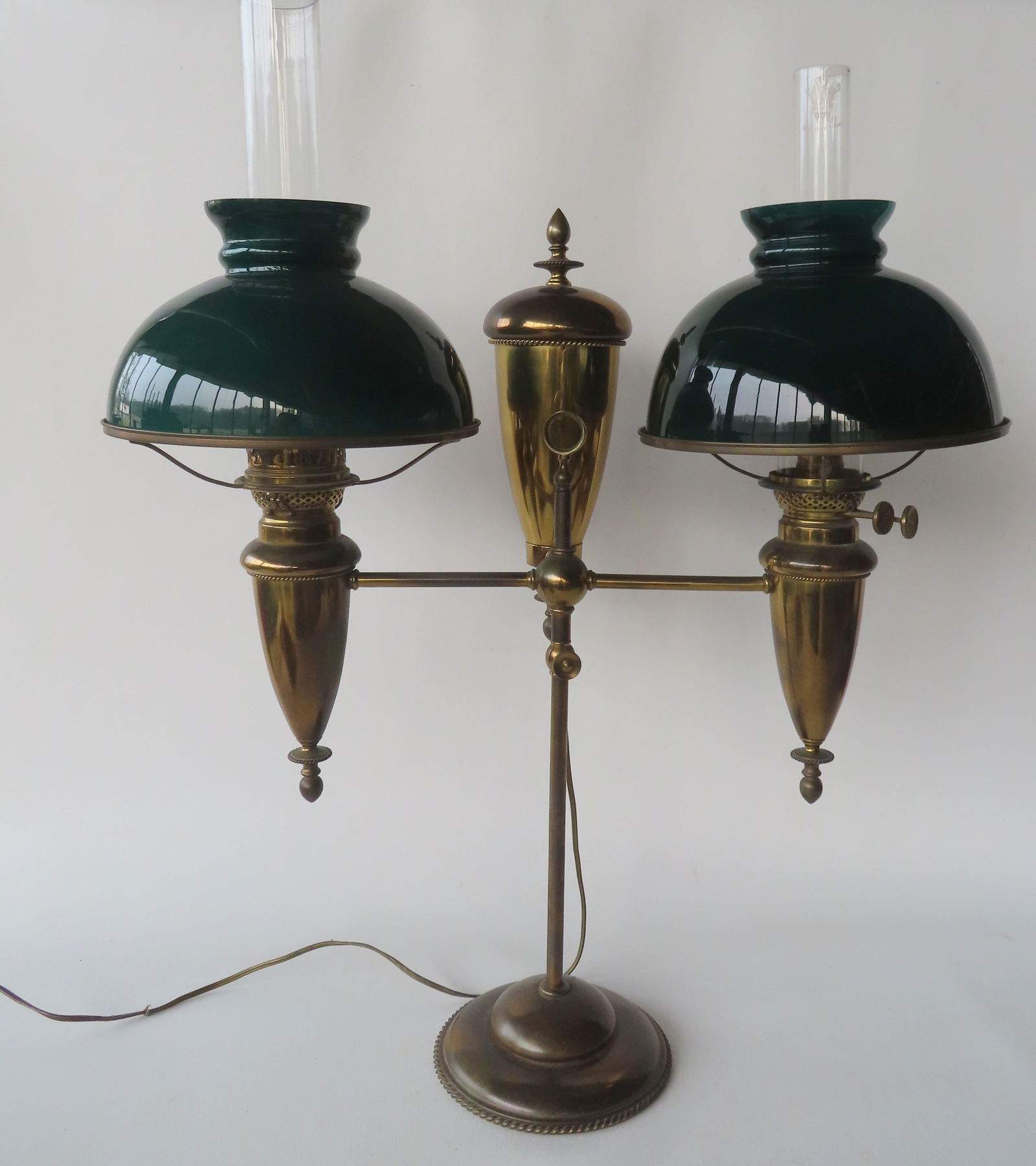 An electrified double font adjustable brass student lamp with green cased glass shades, having (1 of 14)