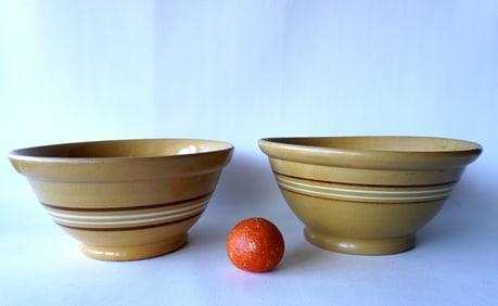 Two large banded mixing bowls with rolled rims and footed bases, both with brown bands surrounding 2