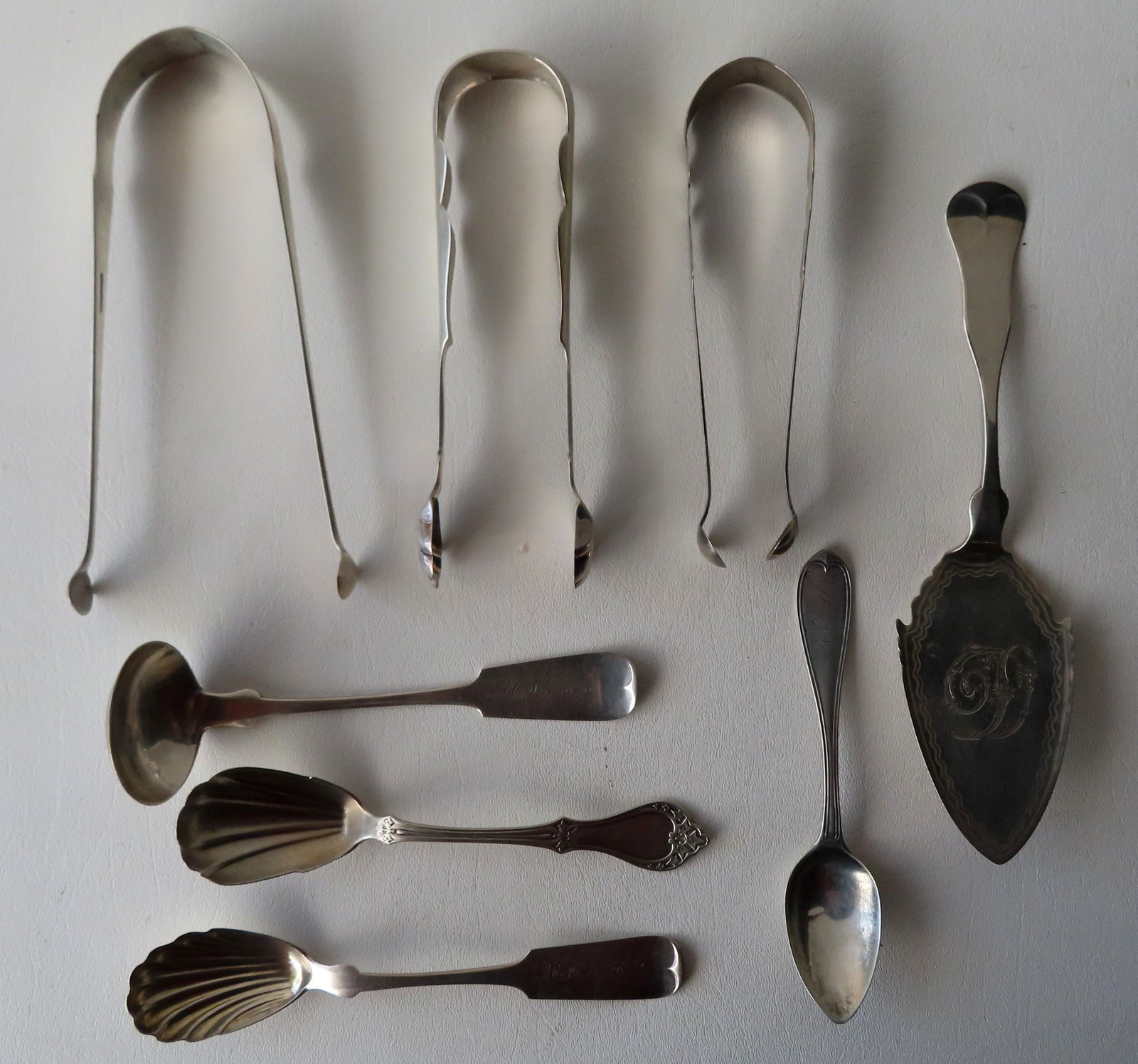 Grouping of 8 coin silver serving pieces, 7 from Poughkeepsie NY,  including 3 sugar tongs, 1 cake (1 of 10)