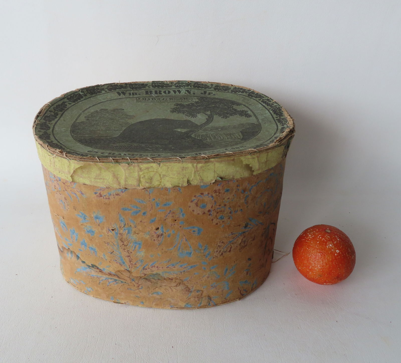 A vintage band box with a lithograph of a beaver overlooking waterfall printed on lid, early to mid (1 of 7)