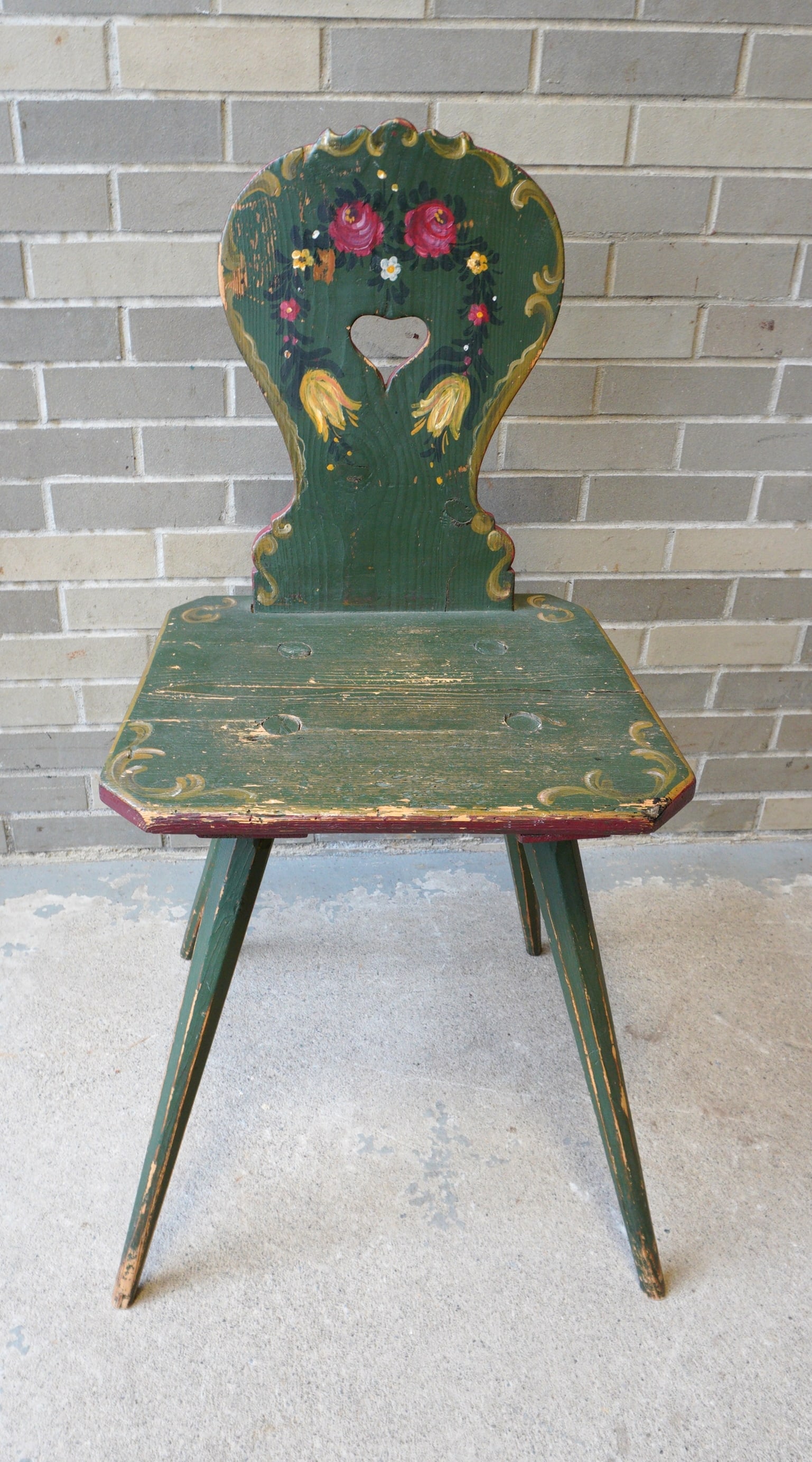 A hand painted side chair decorated with flowers, a heart cutout in seat back, and having splayed (1 of 4)