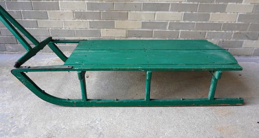 A child's pull sled in old green paint, 19th century - good condition. Measures 45"L x 20 1/2"W x 9