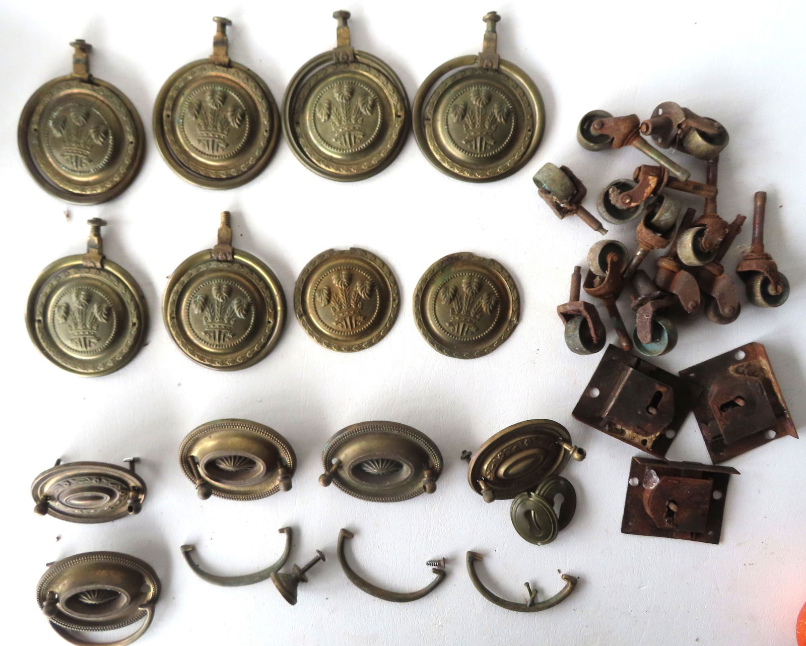 A grouping of federal brass pulls and furniture wheels, early 19th century. See photos for further: A grouping of federal brass pulls and furniture wheels, early 19th century. See photos for further information.