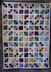 A patchwork quilt, decorated with squares with blue border, circa 1930, hand sewn, very good