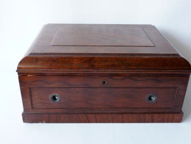 A very fine exotic wood lined silver box with domed top, lower drawer, side handles and original