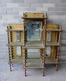 A hand made mirror-back open front etergere having 6 mirrors, 8 legs constructed from sewing spools