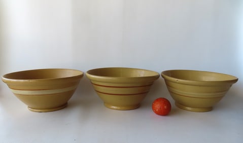 Three large banded yellowware mixing bowls with rolled rims on footed bases, 19th century. Each