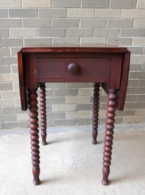 Early 1 drawer drop leaf cherry sewing stand with spool turned legs 1830-1860. The top is stained in