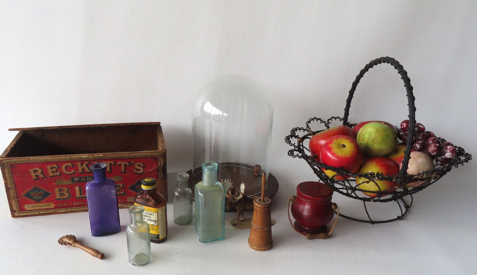A grouping of country collectibles including: A wire basket holding wooden apples and 3 pieces of (1 of 10)