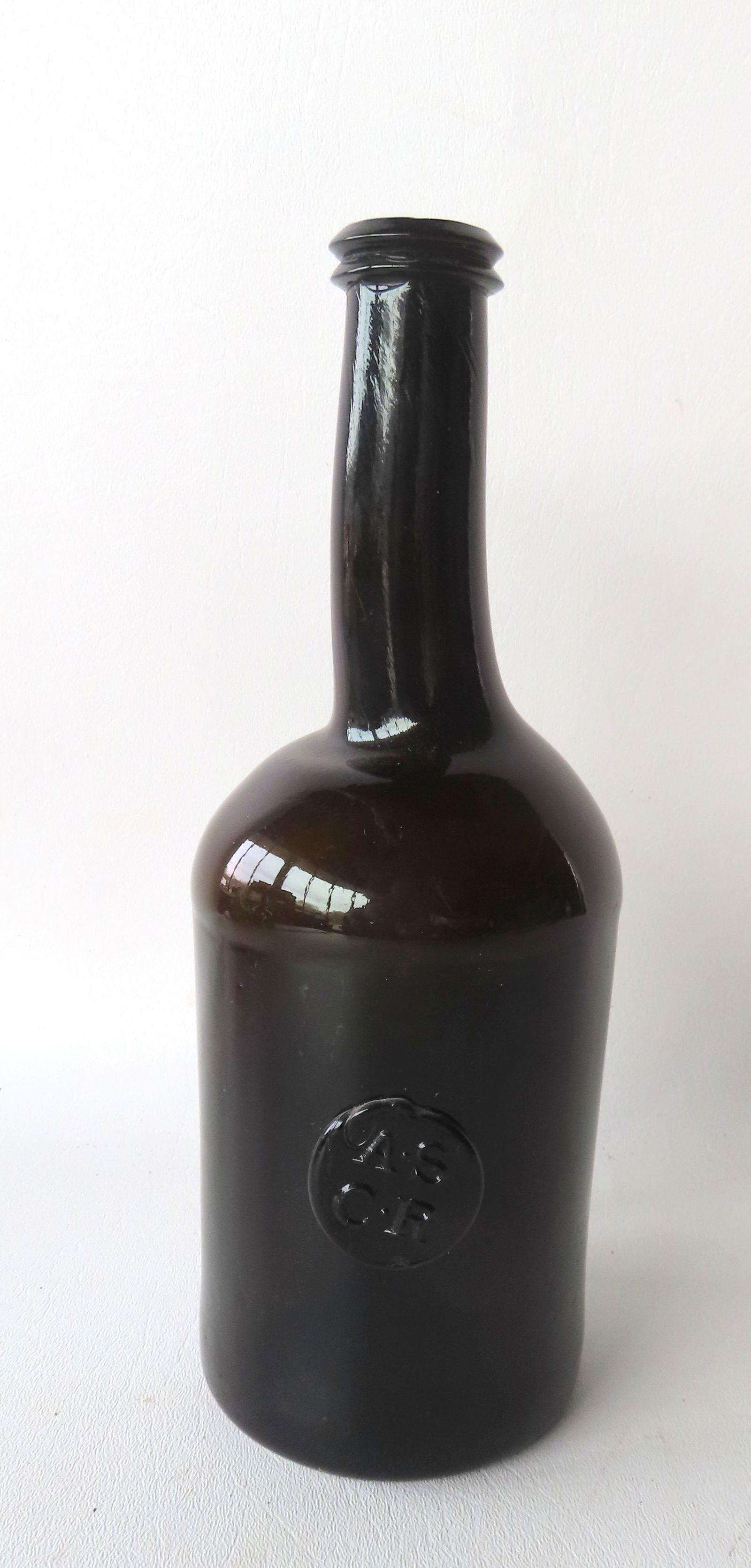 A wine bottle with applied seal marked "A.S. / C. R.", 18th century.: A wine bottle with applied seal marked "A.S. / C. R." (All Souls Common Room), kicked-in bottom and applied lip, dark amber color, probably 18th century. No damage and in very good condition - 10 1/2"
