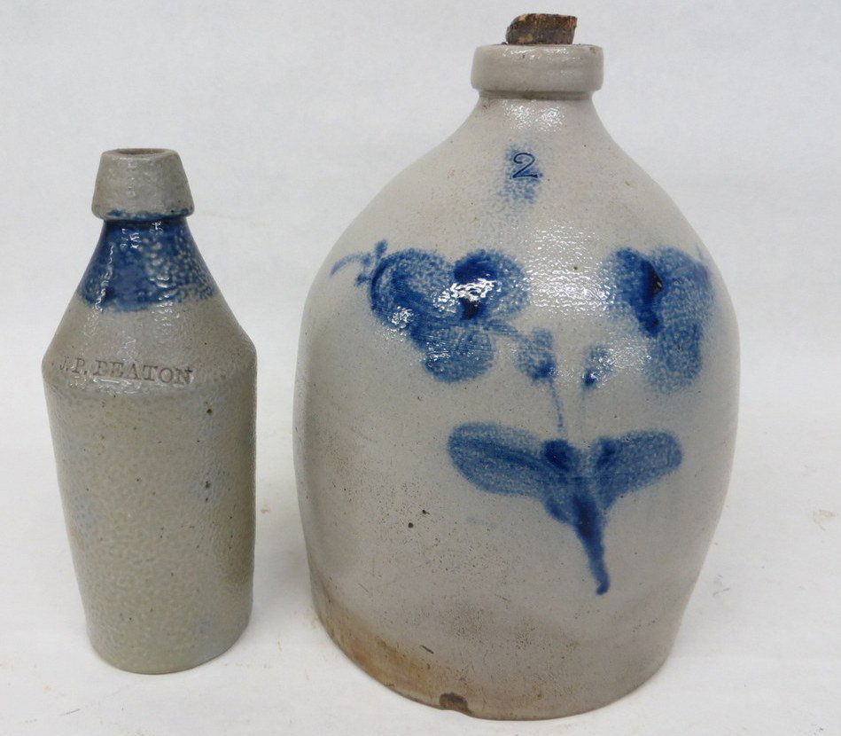 Two piece of stoneware: 2 gal. jug with double flo: Two piece of stoneware: 2 gal. jug with double flower & a stoneware beer bottle with cobalt blue band around neck signed J.P. Beaton.