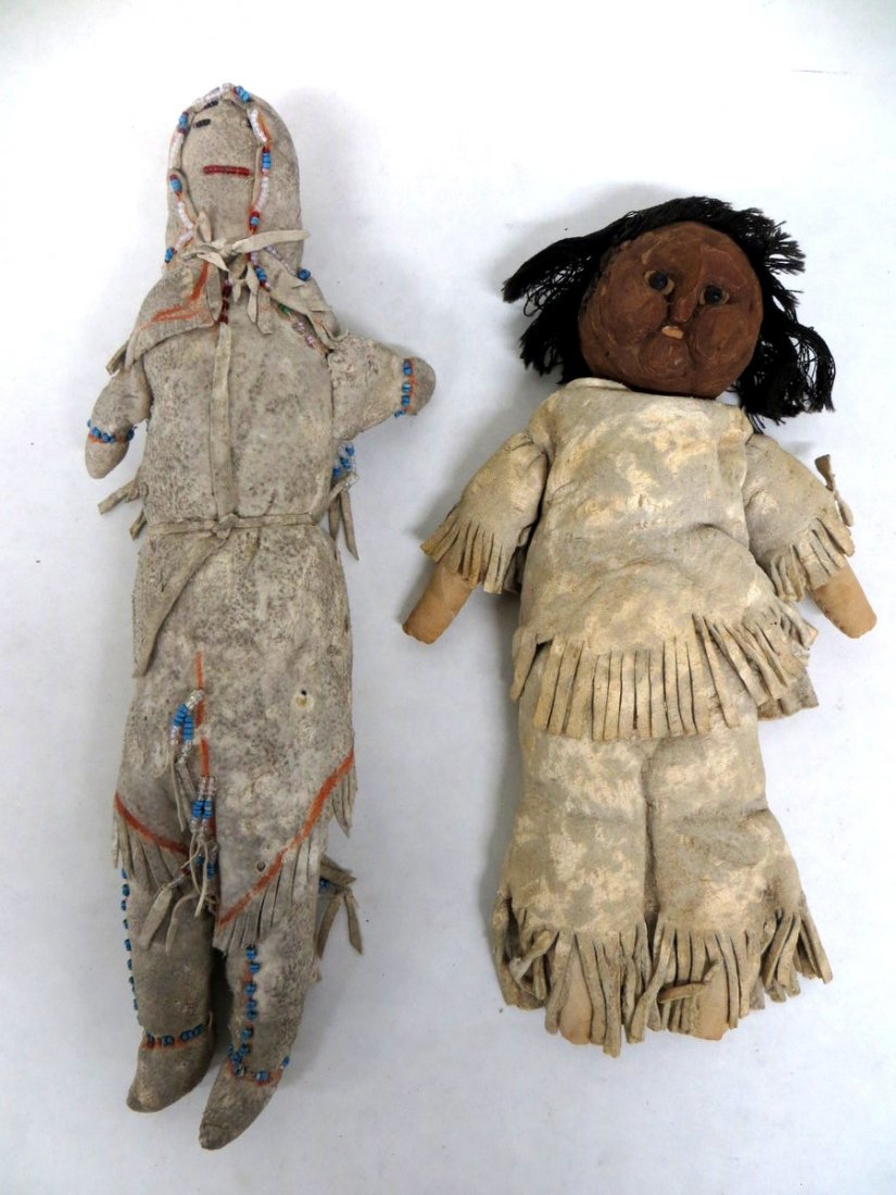 Two early Native American California dolls from mu: Two early Native American California dolls from museum deaccession, one with bark face and original animal hide costume and glass eyes - 11.25"H, the other all animal hide with beadwork face and ornam