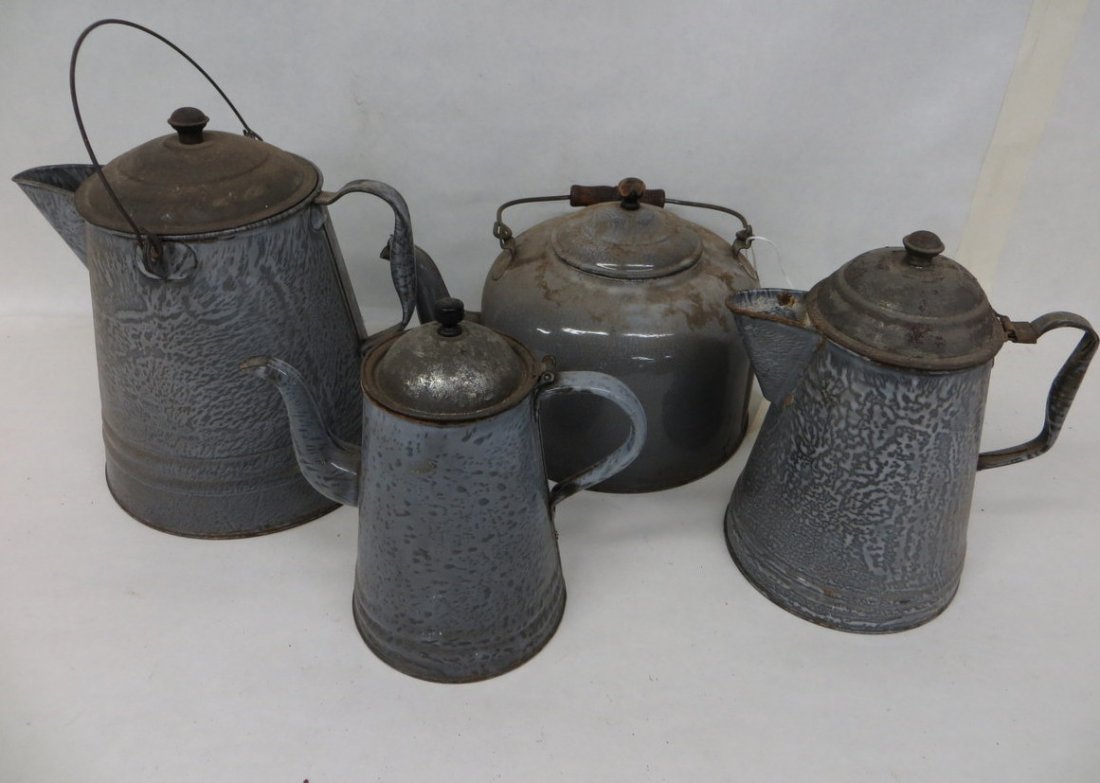 Four gray graniteware tea kettles.: Four gray graniteware tea kettles.