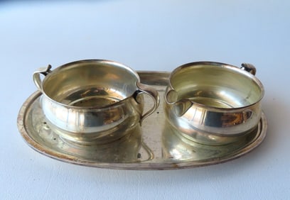 A sterling sugar, creamer and matching tray signed "C. C. Hermann / Denmark / Sterling / x56" - the