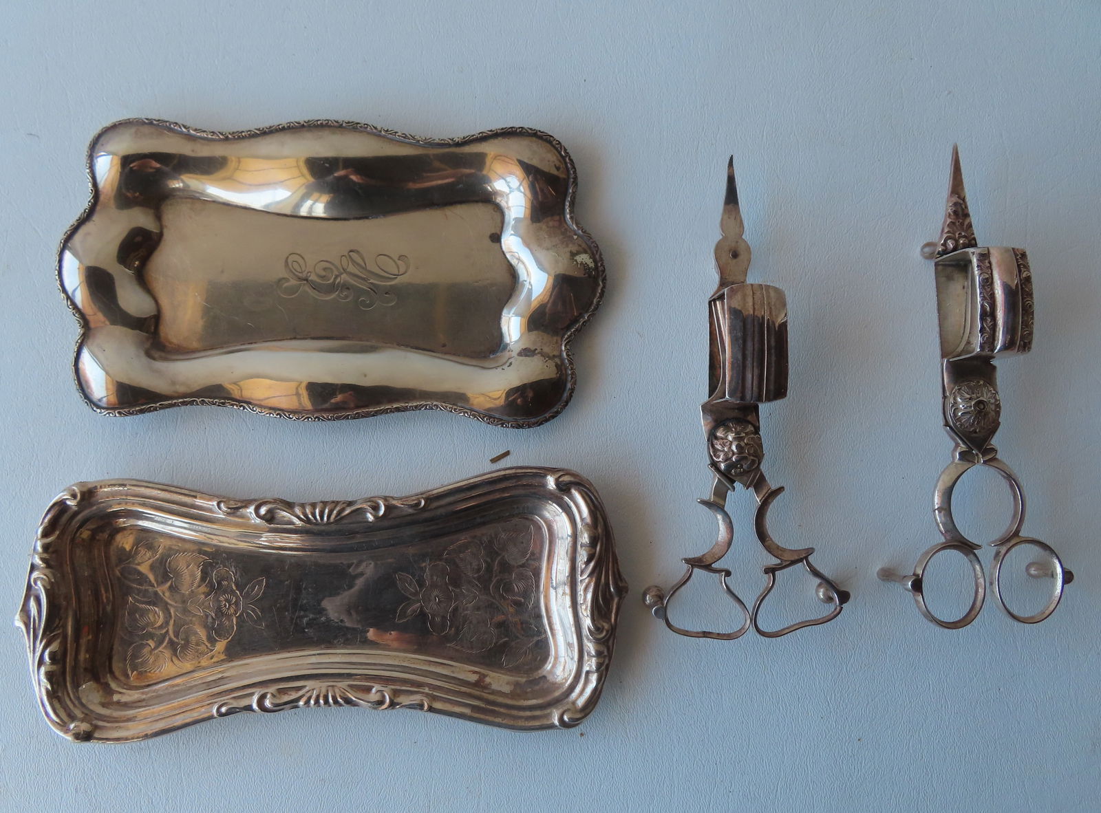 Two silver candle snuffers with silver trays. The first tray engraved with flowers in not marked, (1 of 9)