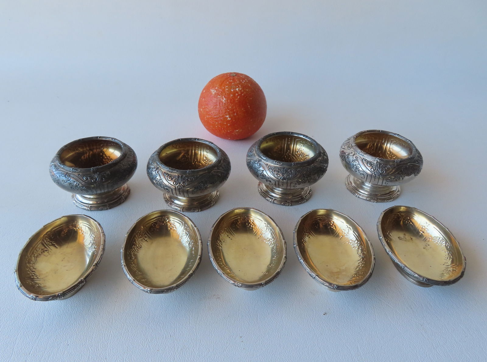 Grouping of 9 sterling silver hand chased classical style salt cellars with gold wash interiors and (1 of 9)