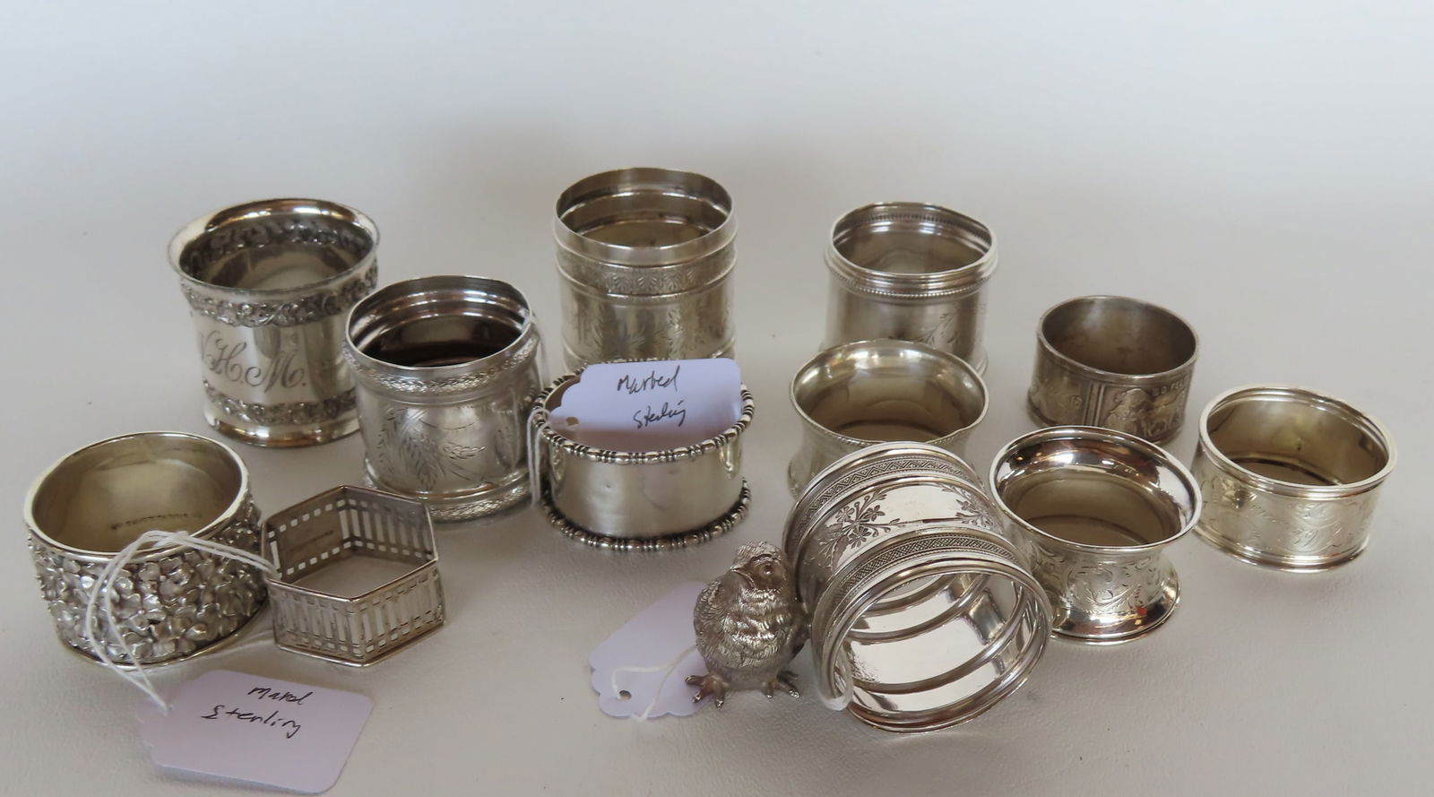 Grouping of 13 non-matching silver napkin rings, most Victorian era, 5 marked sterling weighing 4.2 (1 of 6)