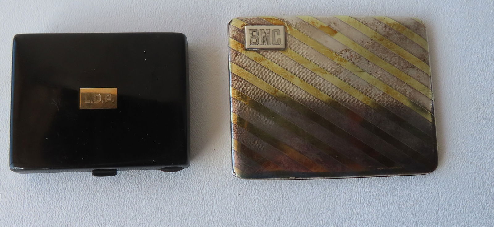 Two Sterling silver cigarette cases. The first with enameled covers and interior marked "Sterling / (1 of 6)