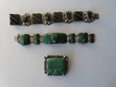 Three pieces of Aztec style Mexican silver jewelry including: Sterling bracelet decorated with onyx