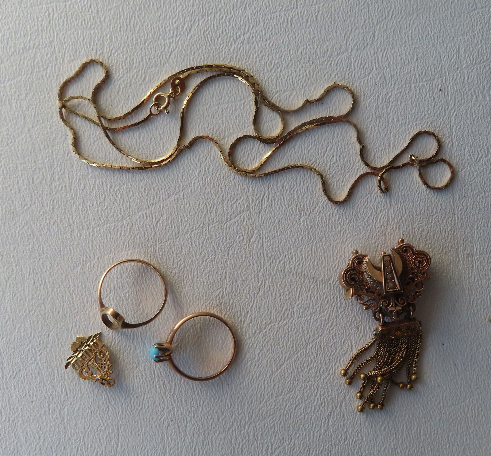 Small grouping of gold lady's jewelry including: Ring, missing stone - tested to 10k; ring with (1 of 4)