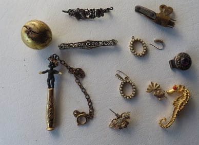 Grouping of jewelry including 2 sterling Art Deco brooches, a gold plated smoking pipe tamper in the