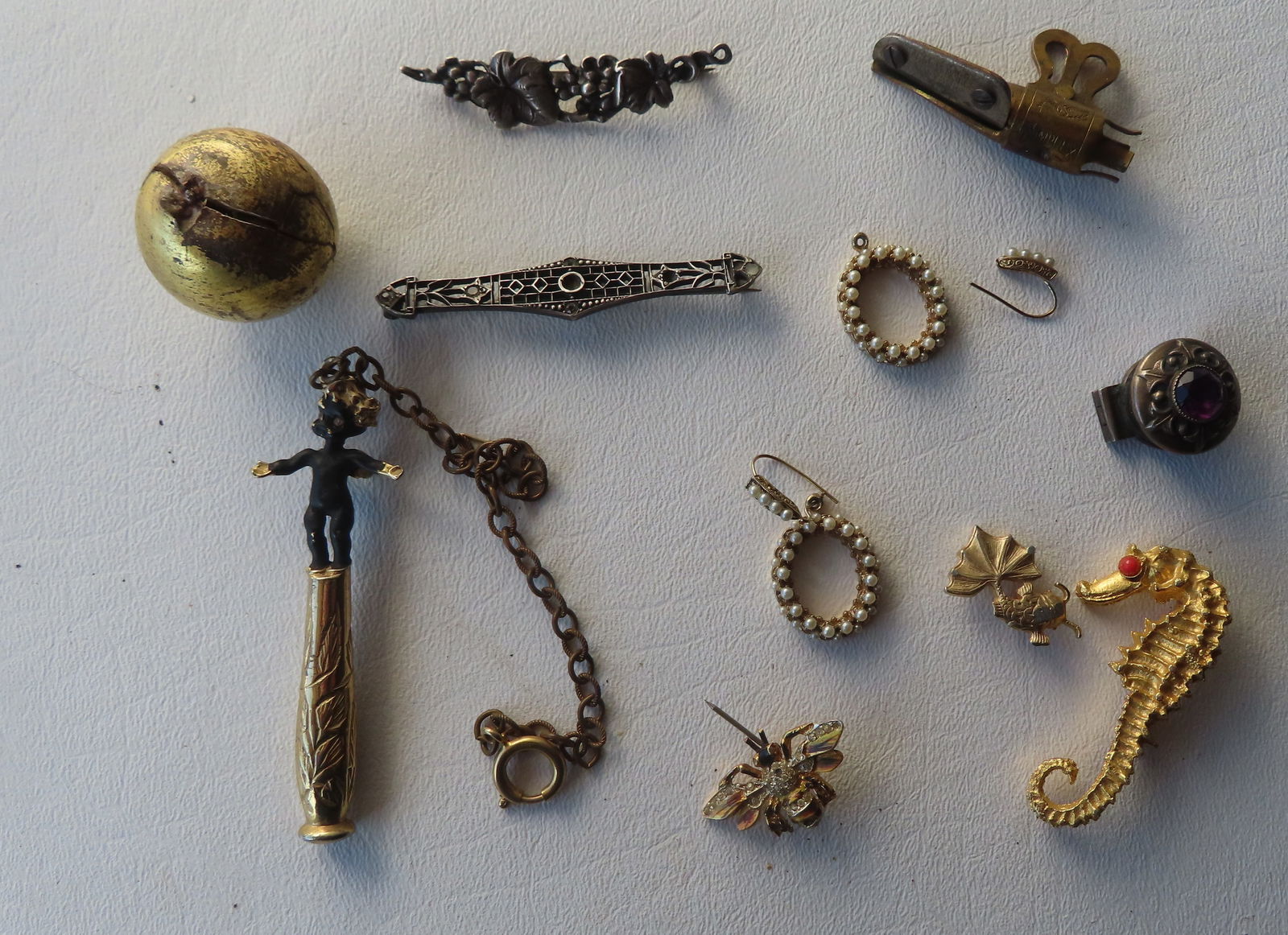 Grouping of jewelry including 2 sterling Art Deco brooches, a gold plated smoking pipe tamper in the (1 of 6)