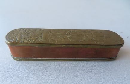 Continental brass tobacco box with impressed royalty crest on lid and naval invasion scene on base