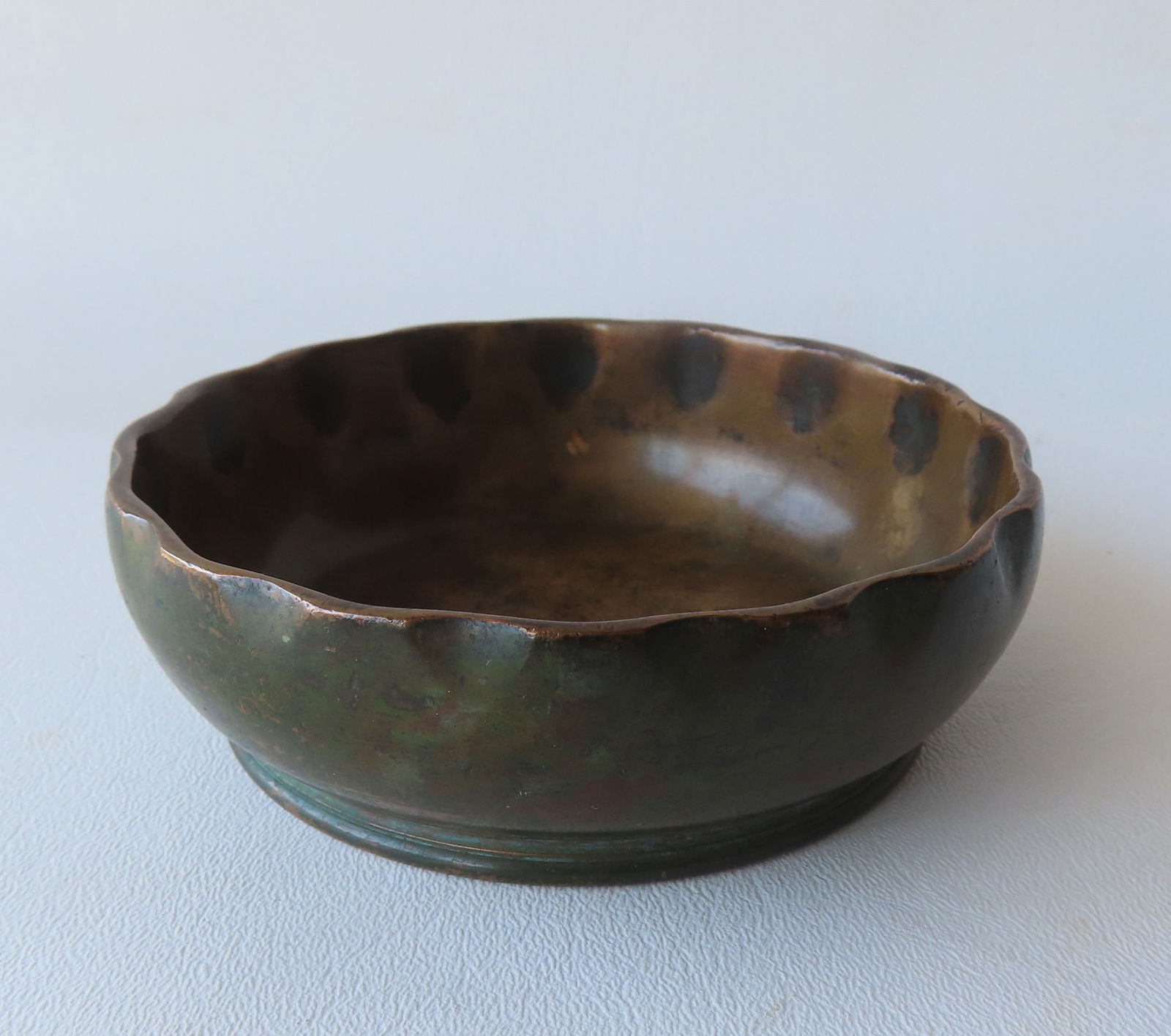 Small "Tiffany Studios / New York / 1719" bronze bowl with ruffled edge. Minor surface wear and: Small "Tiffany Studios / New York / 1719" bronze bowl with ruffled edge. Minor surface wear and overall good condition. Measures 4 1/2" diameter x 2 1/2"H.