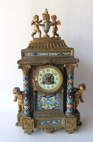 An ornate classical French style shelf clock, appears to be constructed of gilded zinc or white