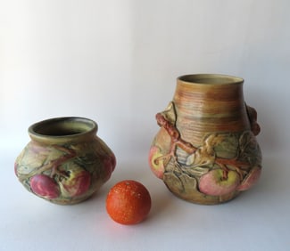 Two Weller vases in the Baldwin Apple pattern. The first measures 9"H x 9"W and has branch shaped
