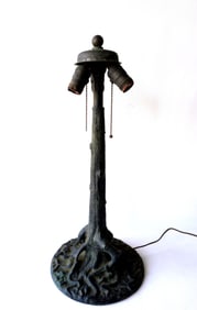 An exceptional bronze lamp base in the form of a tree trunk with exposed roots, circa 1900-20.