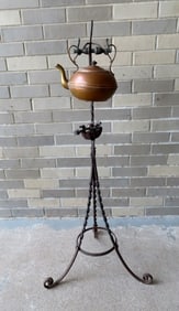 An Arts & Crafts kettle wrought iron stand with original copper tea kettle - burner is included but