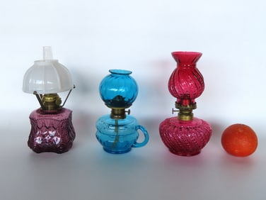 Three miniature oil lamps including cranberry with matching shade - measures 8 7/8"H to top of shade