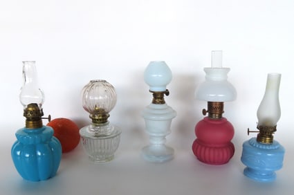 Grouping of 5 miniature oil lamps including 3 with shades. The largest with ribbed sides in opaque