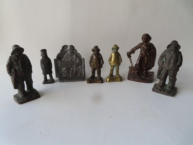 Grouping of 8 metal door stops and bookends, some cast iron and a pair of lead bookends signed "The